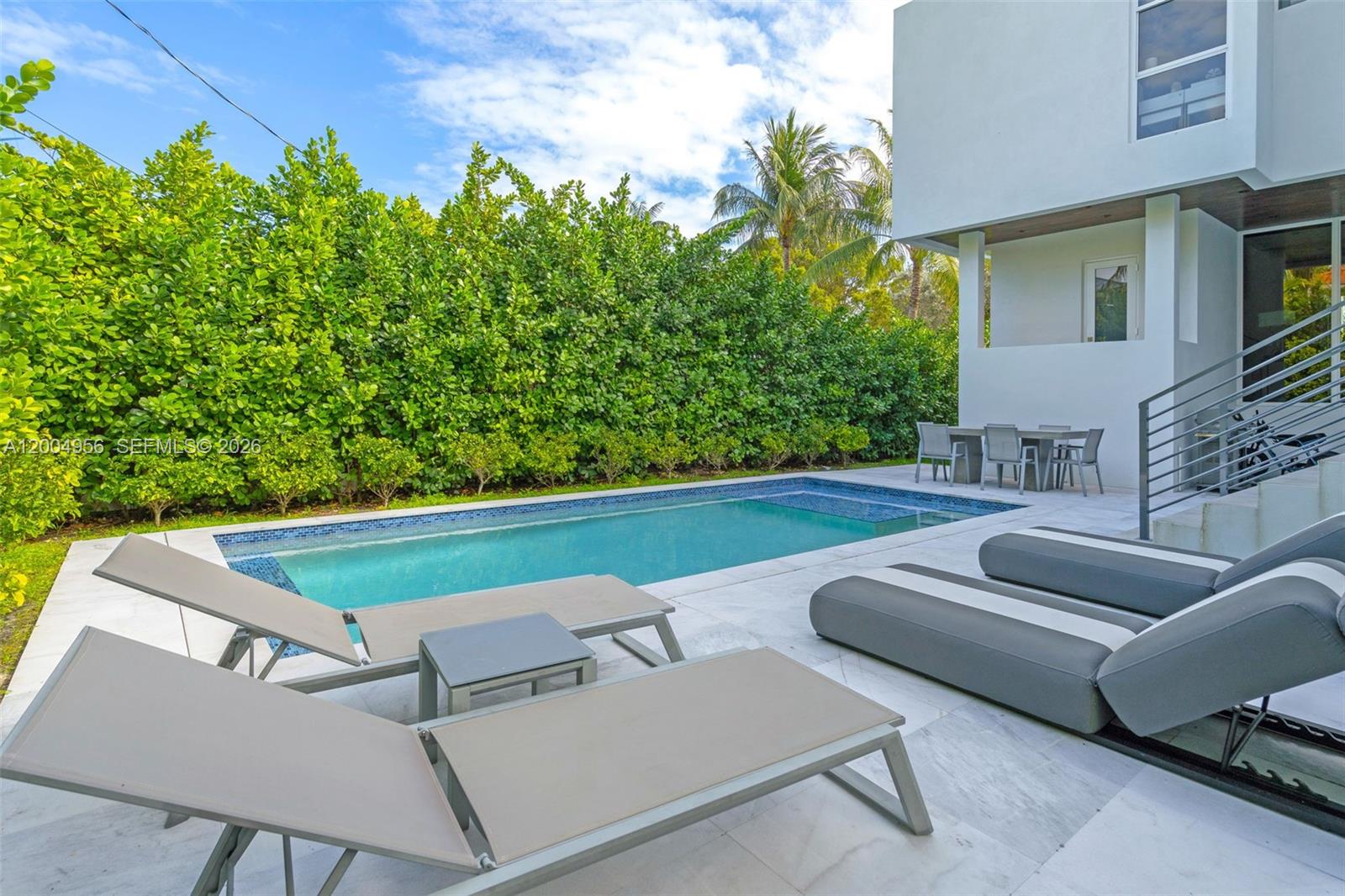285 West Mashta Drive Key Biscayne, FL 33149 - Photo 37 of 42 a view of a patio with couches under an umbrella