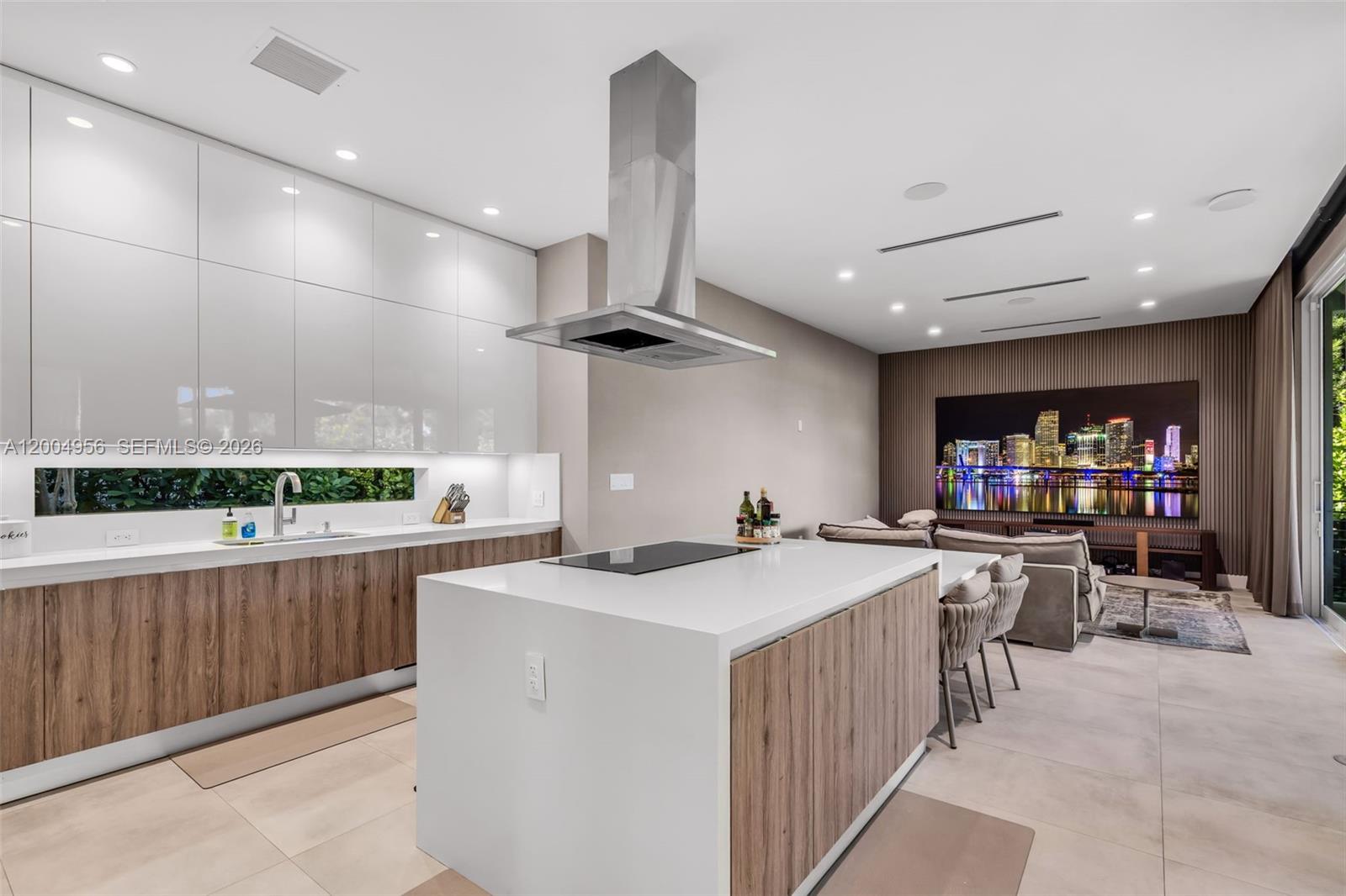 285 West Mashta Drive Key Biscayne, FL 33149 - Photo 9 of 42 a kitchen with a sink a counter top space stainless steel appliances and a large window