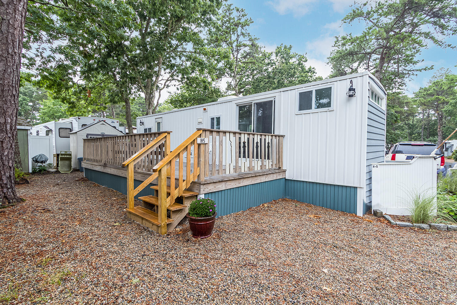 a view of a house with a yard and a wooden deck