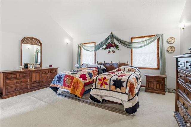 811 East Canyon Road Mayfield, UT 84643 - Photo 19 of 57 Spacious room featuring vaulted ceilings, light-toned carpeting, and multiple windows with wood trim