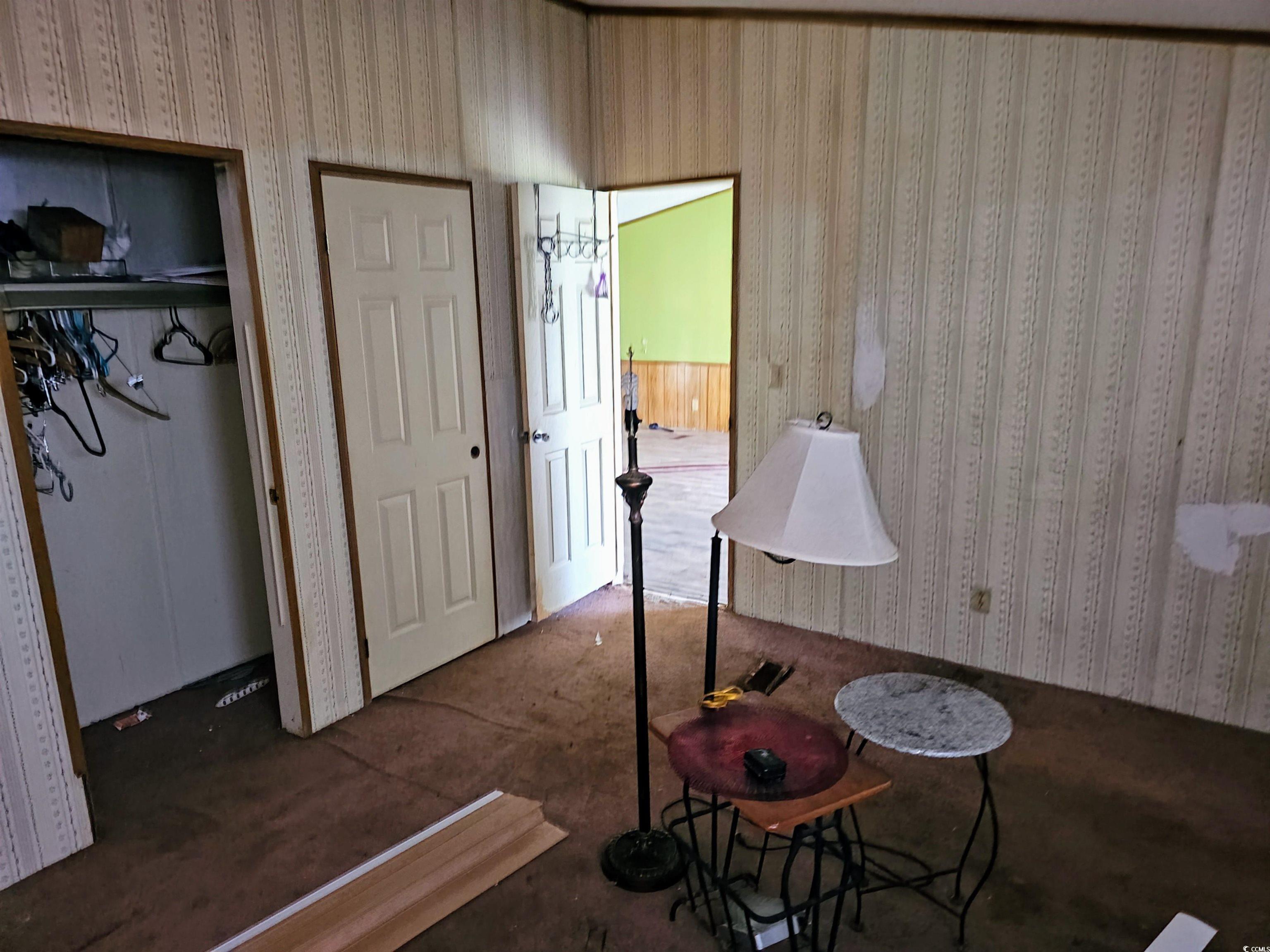 827 1/2 North Firetower Road Florence, SC 29506 - Photo 13 of 29 Bedroom with wallpapered walls and a closet