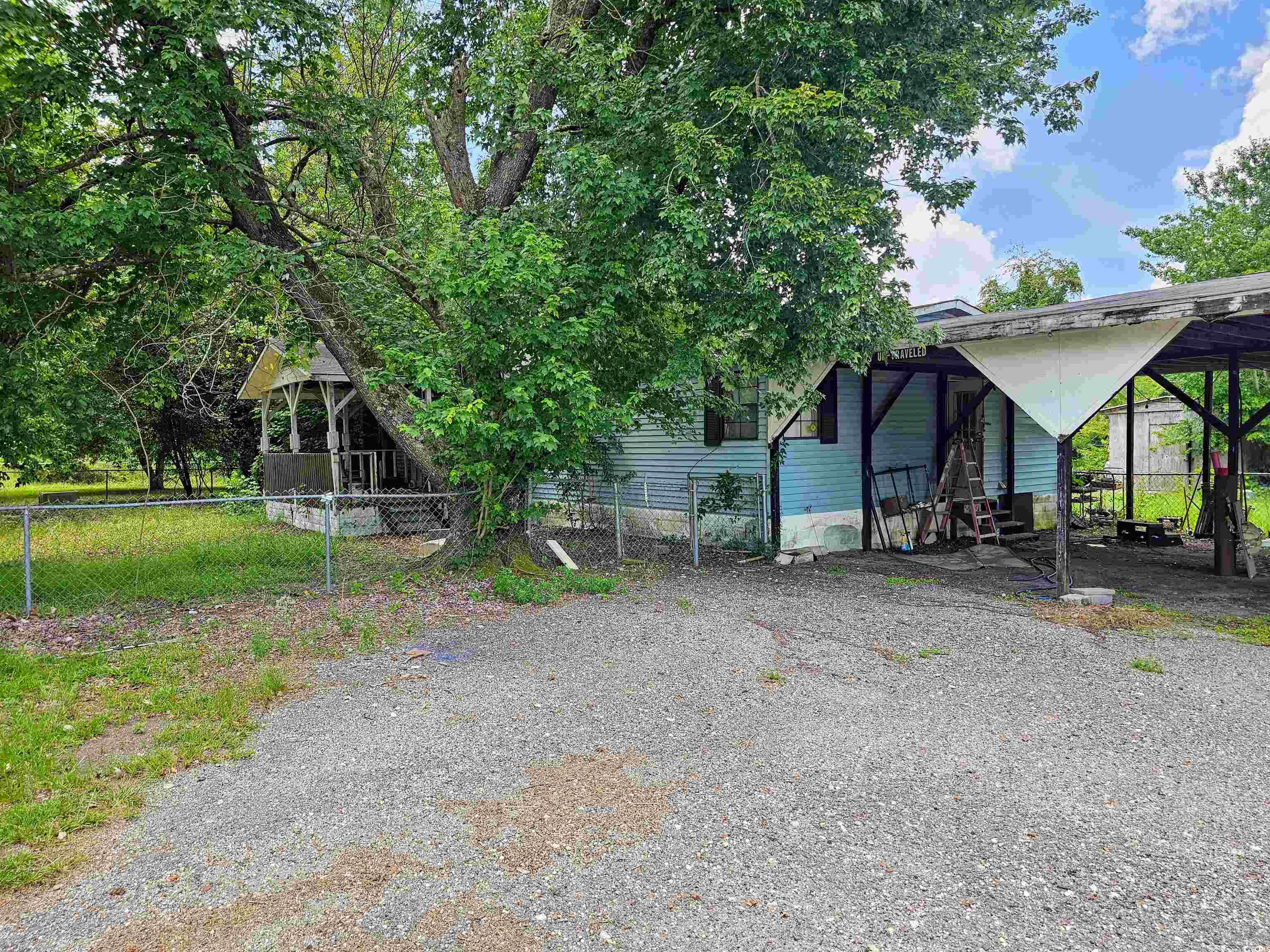 827 1/2 North Firetower Road Florence, SC 29506 - Photo 26 of 29 Fenced yard with driveway and a carport