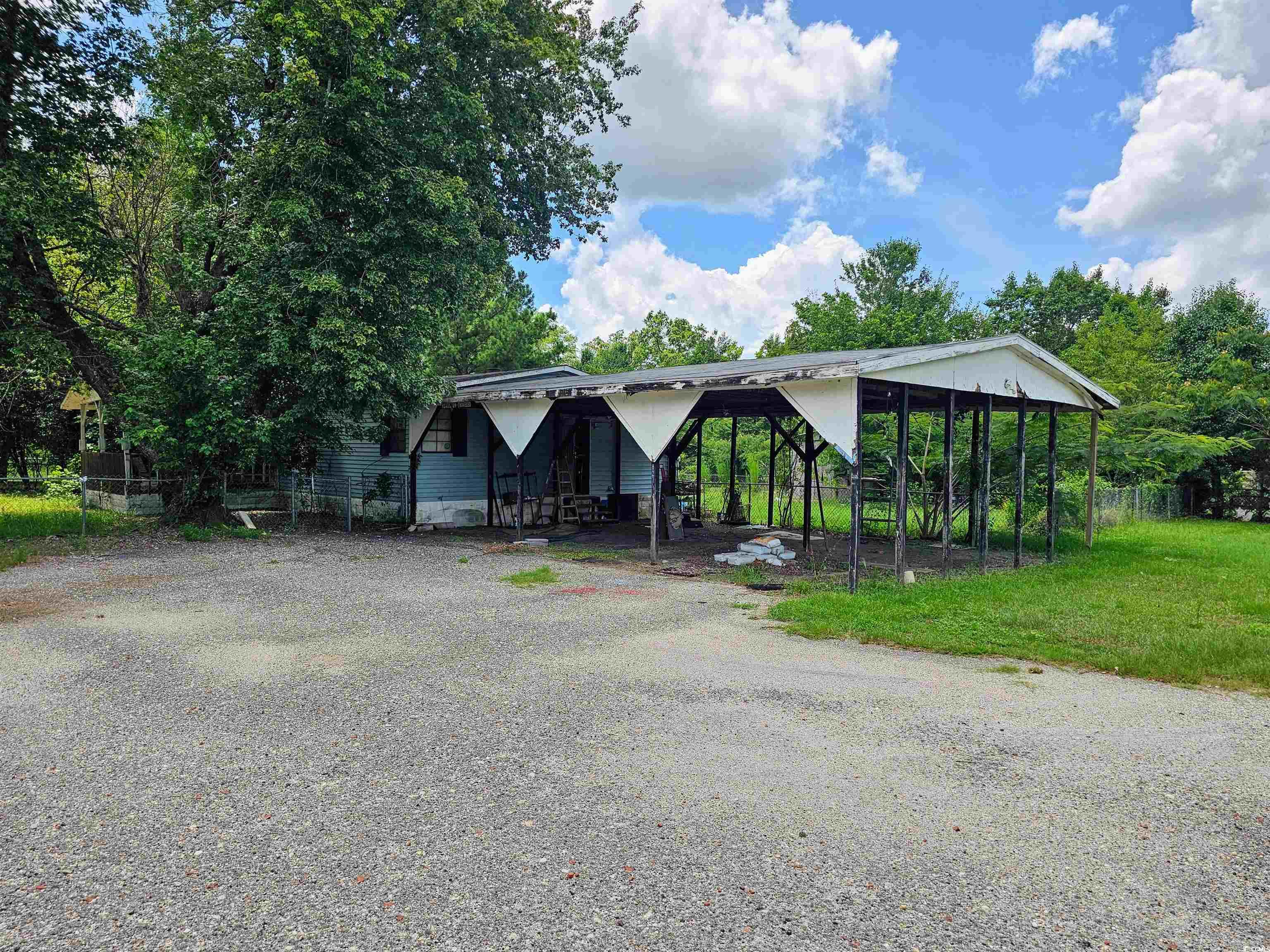 827 1/2 North Firetower Road Florence, SC 29506 - Photo 3 of 29 View of front of home featuring driveway and a carport
