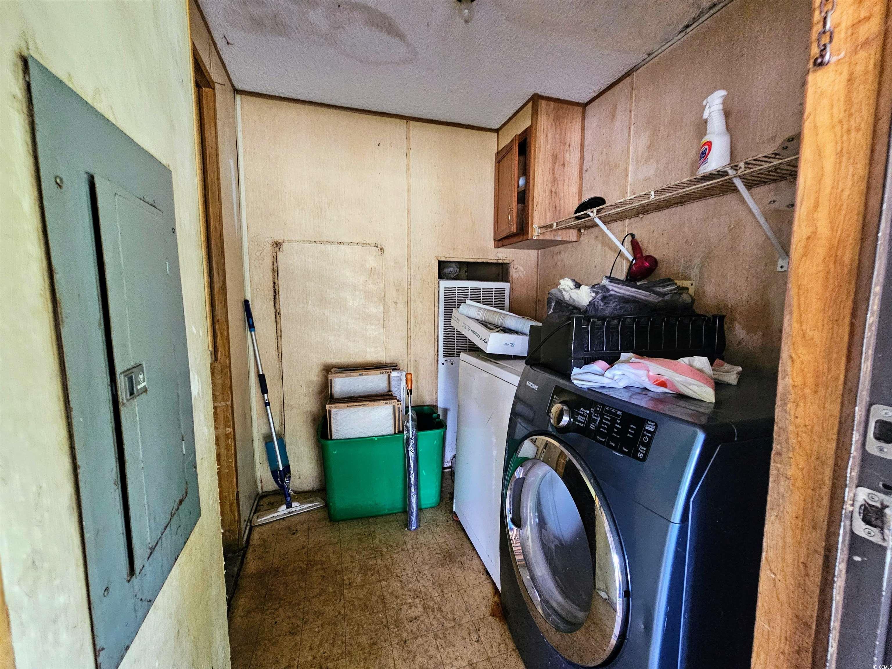 827 1/2 North Firetower Road Florence, SC 29506 - Photo 6 of 29 Laundry room with separate washer and dryer, cabinet space, a textured ceiling, and tile patterned floors