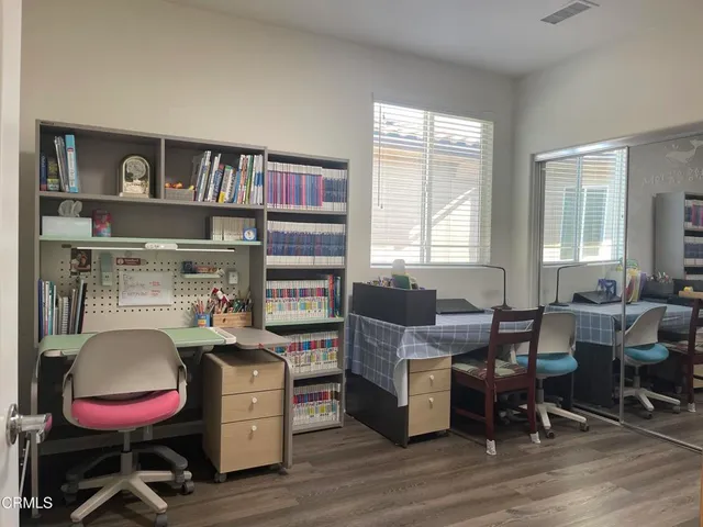 a dining room with furniture and wooden floor