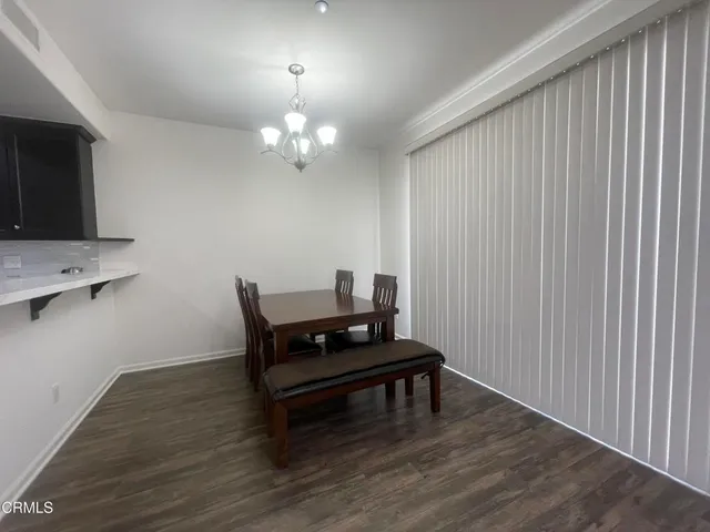 a living room with furniture and a kitchen counter space