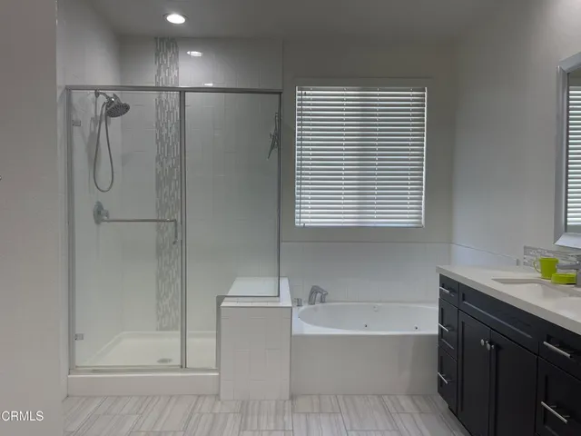 a bathroom with a double vanity sink toilet and shower