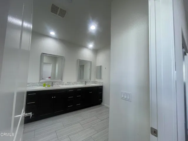 a bathroom with a toilet a sink and a window