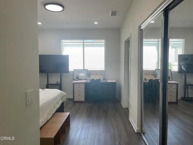 a view of a refrigerator in kitchen and a window