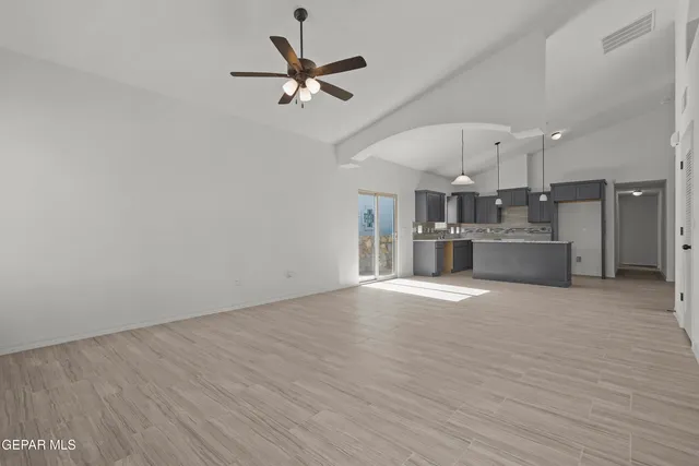 a view of a kitchen with a sink and a refrigerator