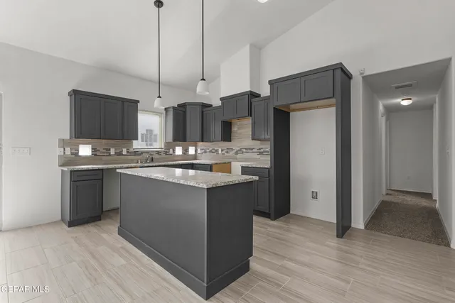 a kitchen with stainless steel appliances a refrigerator sink and microwave