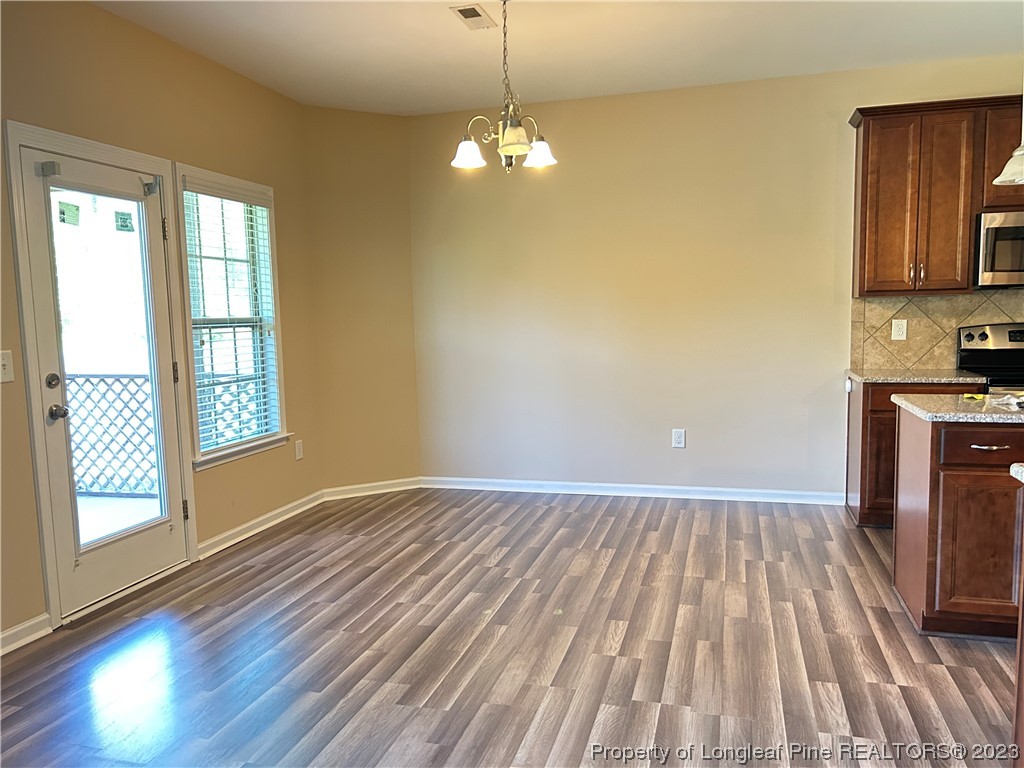 145 Taplow Trail Cameron, NC 28326 - Photo 5 of 15 a view of a room with wooden floor a ceiling fan and windows