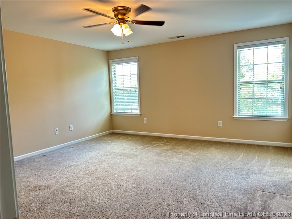 145 Taplow Trail Cameron, NC 28326 - Photo 9 of 15 an empty room with windows and fan