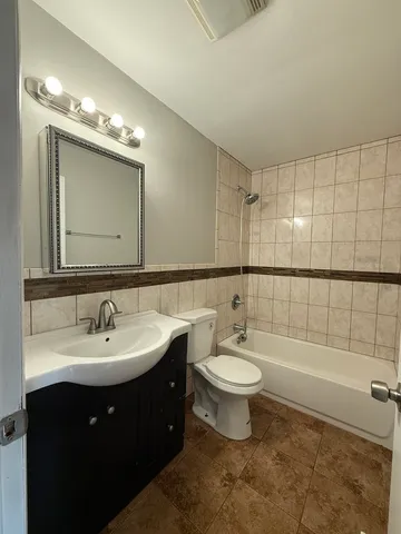 a bathroom with a double vanity sink mirror and toilet