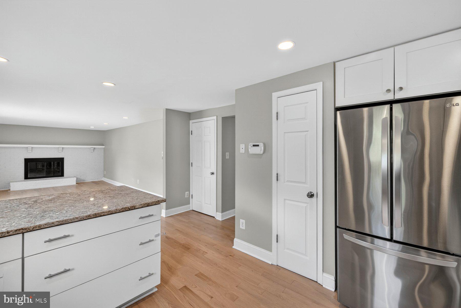 7518 Candytuft Court Springfield, VA 22153 - Photo 12 of 47 a view of kitchen island wooden floor center island and stainless steel appliances