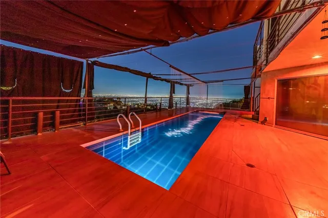 a view of a chairs and table in backyard of the house