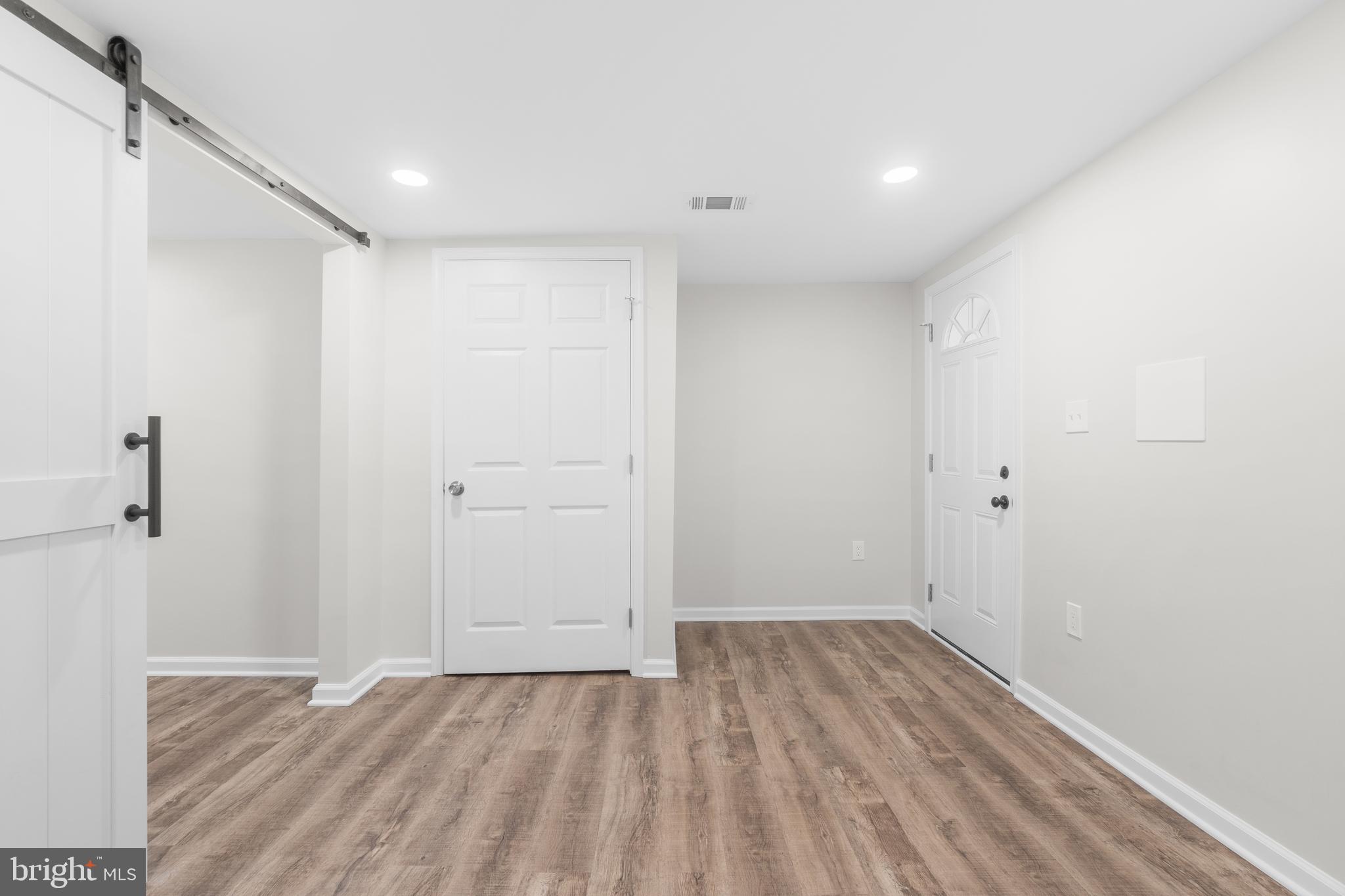 4686 A Street Southeast Washington, DC 20019 - Photo 24 of 28 a view of a room with wooden floor and white walls