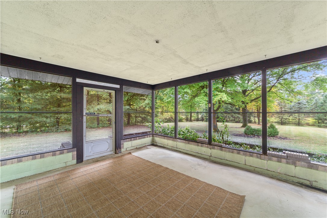 648 Rehwinkle Road Northfield, OH 44067 - Photo 10 of 38 Unfurnished sunroom with unfinished concrete floors