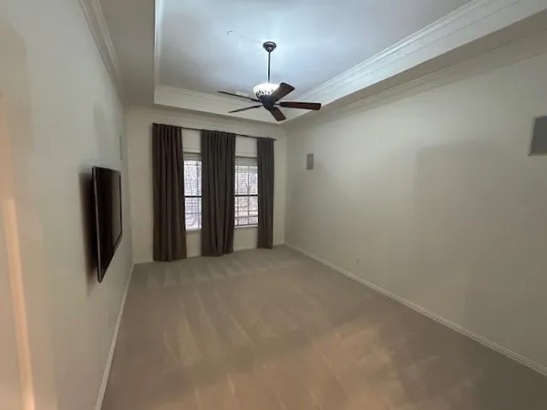 a view of a livingroom with a chandelier fan and a window