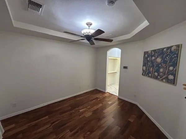 a view of a livingroom with a chandelier fan and a window