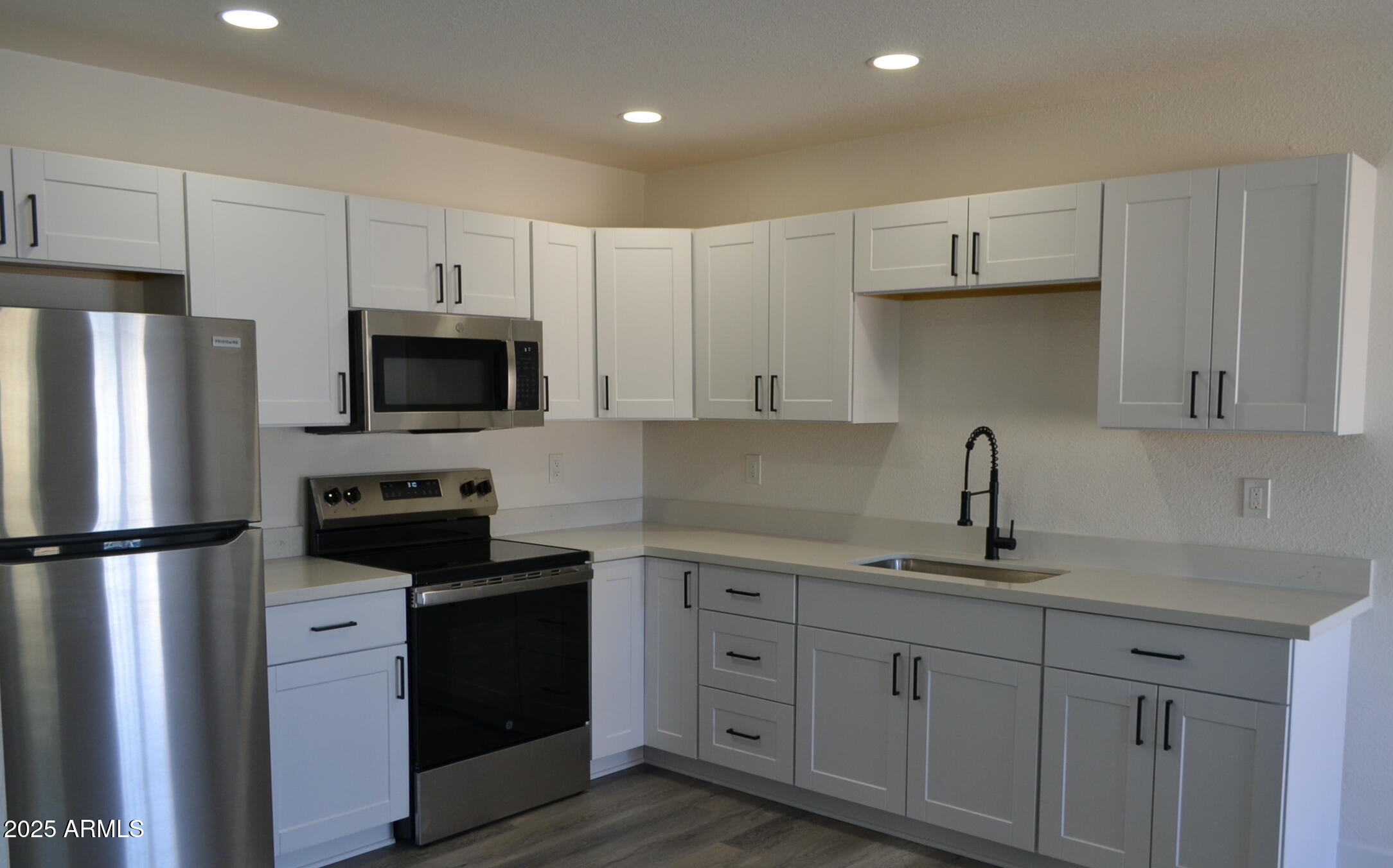 44 North Mountain Road, Unit 2 Apache Junction, AZ 85120 - Photo 2 of 7 a kitchen with cabinets stainless steel appliances and a counter space