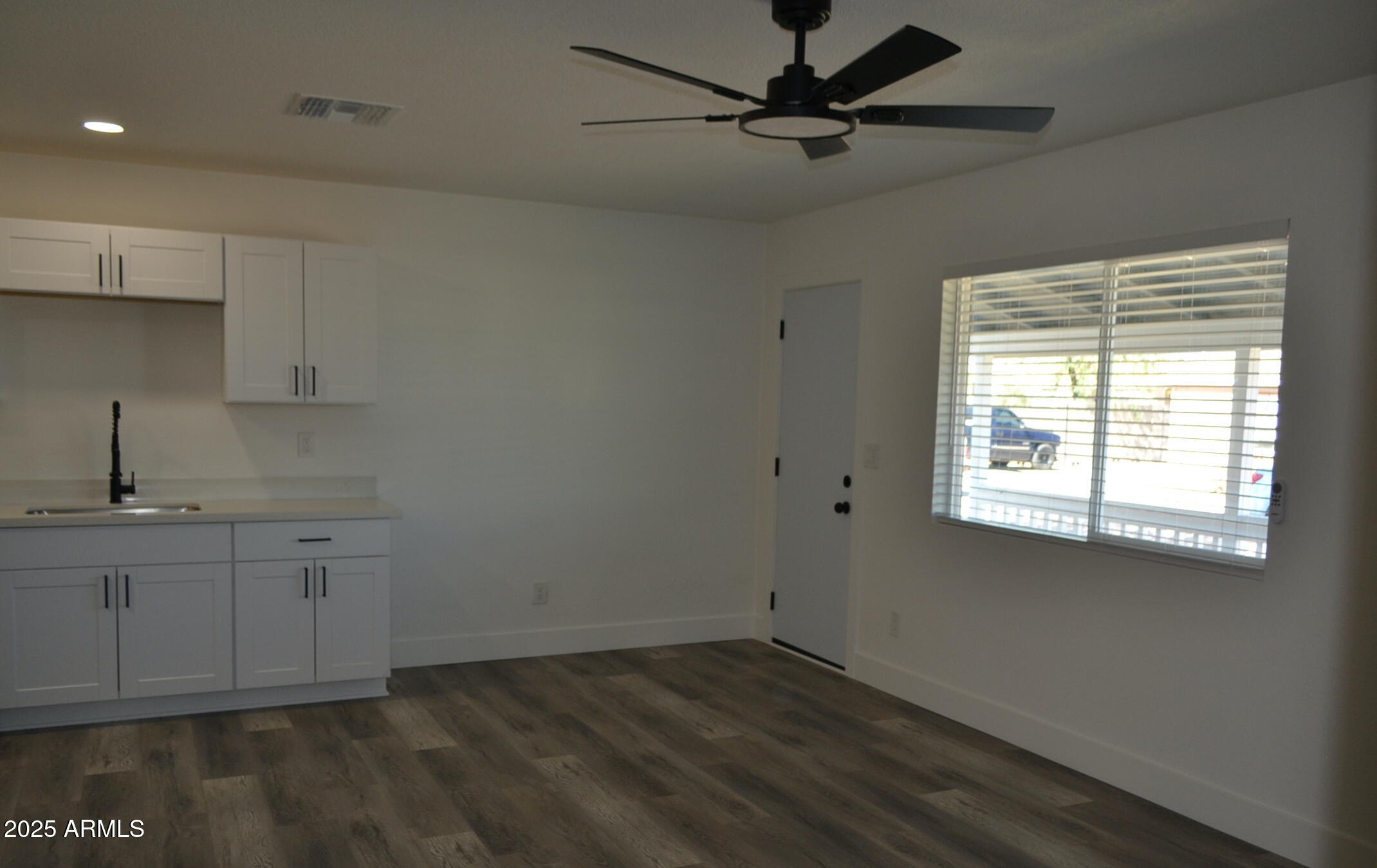 44 North Mountain Road, Unit 2 Apache Junction, AZ 85120 - Photo 3 of 7 a view of a kitchen with a sink hardwood floor and a window