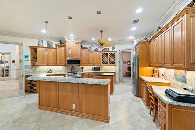 a kitchen with stainless steel appliances granite countertop a sink a stove and a wooden floors