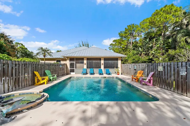 a backyard of a house with barbeque oven table and chairs