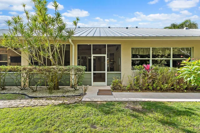 a bedroom with furniture and large window
