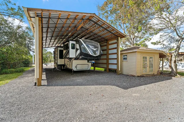 a view of a swimming pool with a patio and a yard