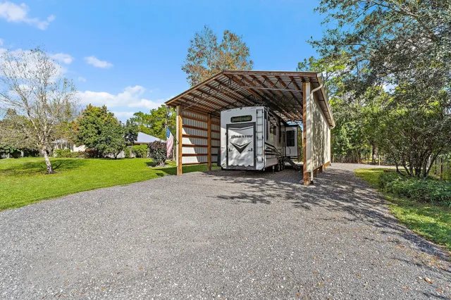 a view of a swimming pool with a patio and a slide