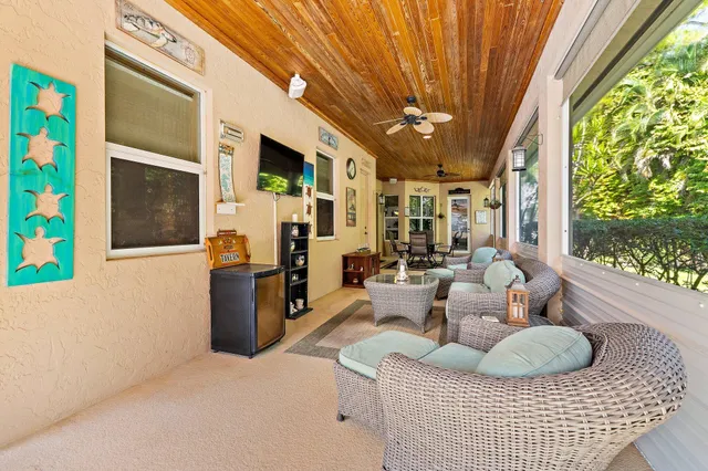 a front view of a house with a yard and potted plants