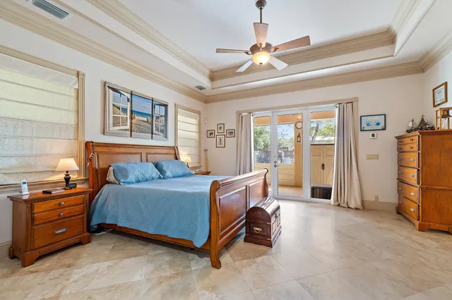 a front view of a house with a yard and potted plants