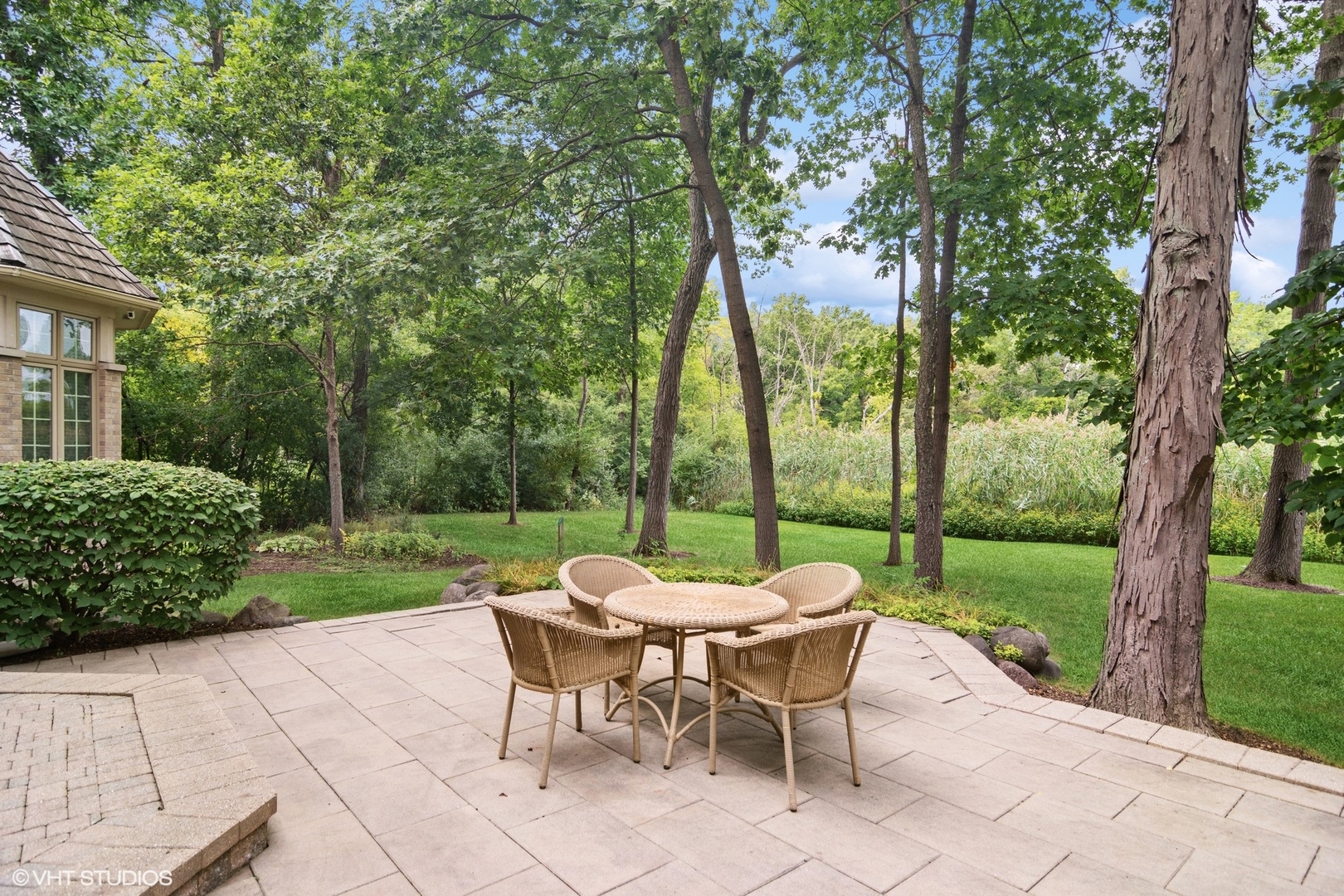 4713 Wellington Drive Long Grove, IL 60047 - Photo 7 of 8 a view of a patio with a table chairs and a garden
