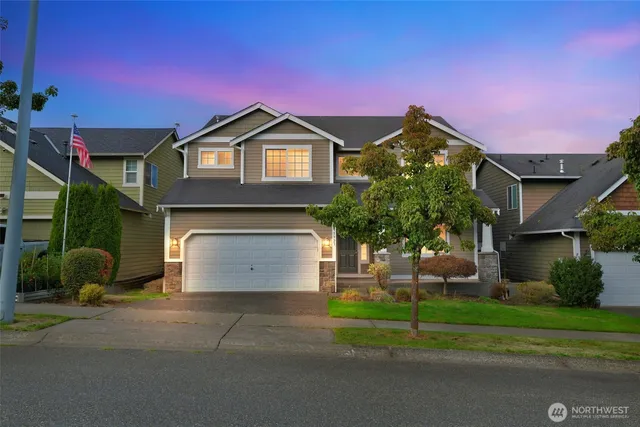 a front view of a house with a yard and garage