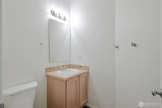 a bathroom with a sink toilet and vanity