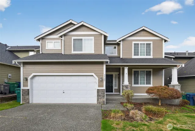 a front view of a house with a yard and garage