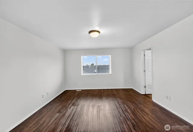 a view of room with window and wooden floor