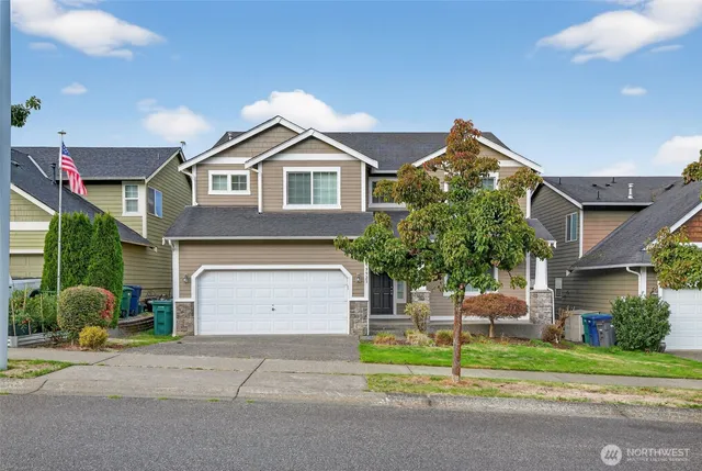 a front view of a house with a yard and garage