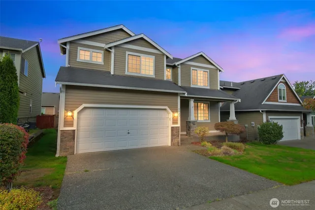 a front view of a house with a yard and garage