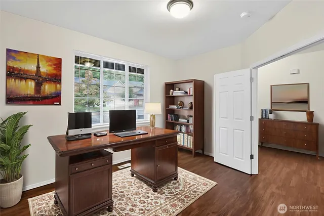 a view of a workspace with furniture and a window