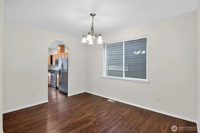 a view of a livingroom with wooden floor and a window