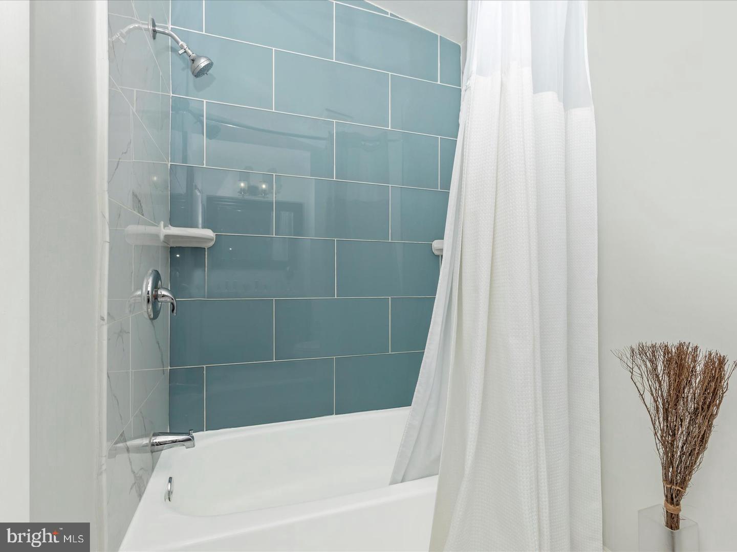 11349 Appledowre Way, Unit 313 Germantown, MD 20876 - Photo 15 of 27 a bathroom with a shower curtain and a bathtub