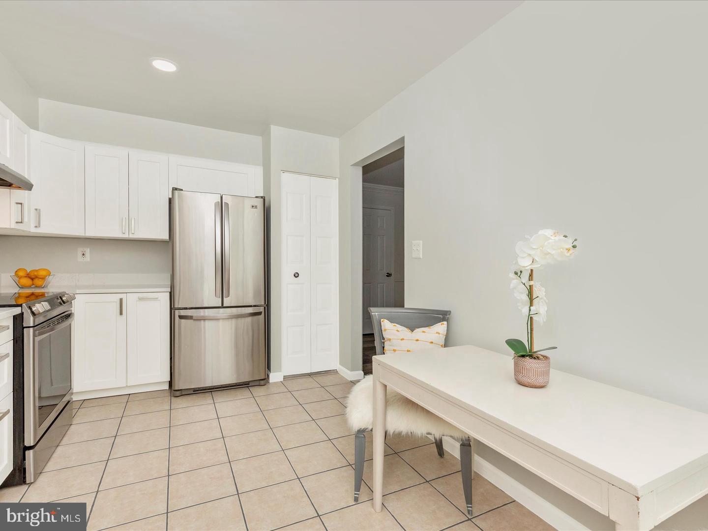 11349 Appledowre Way, Unit 313 Germantown, MD 20876 - Photo 3 of 27 a kitchen with stainless steel appliances a refrigerator and sink