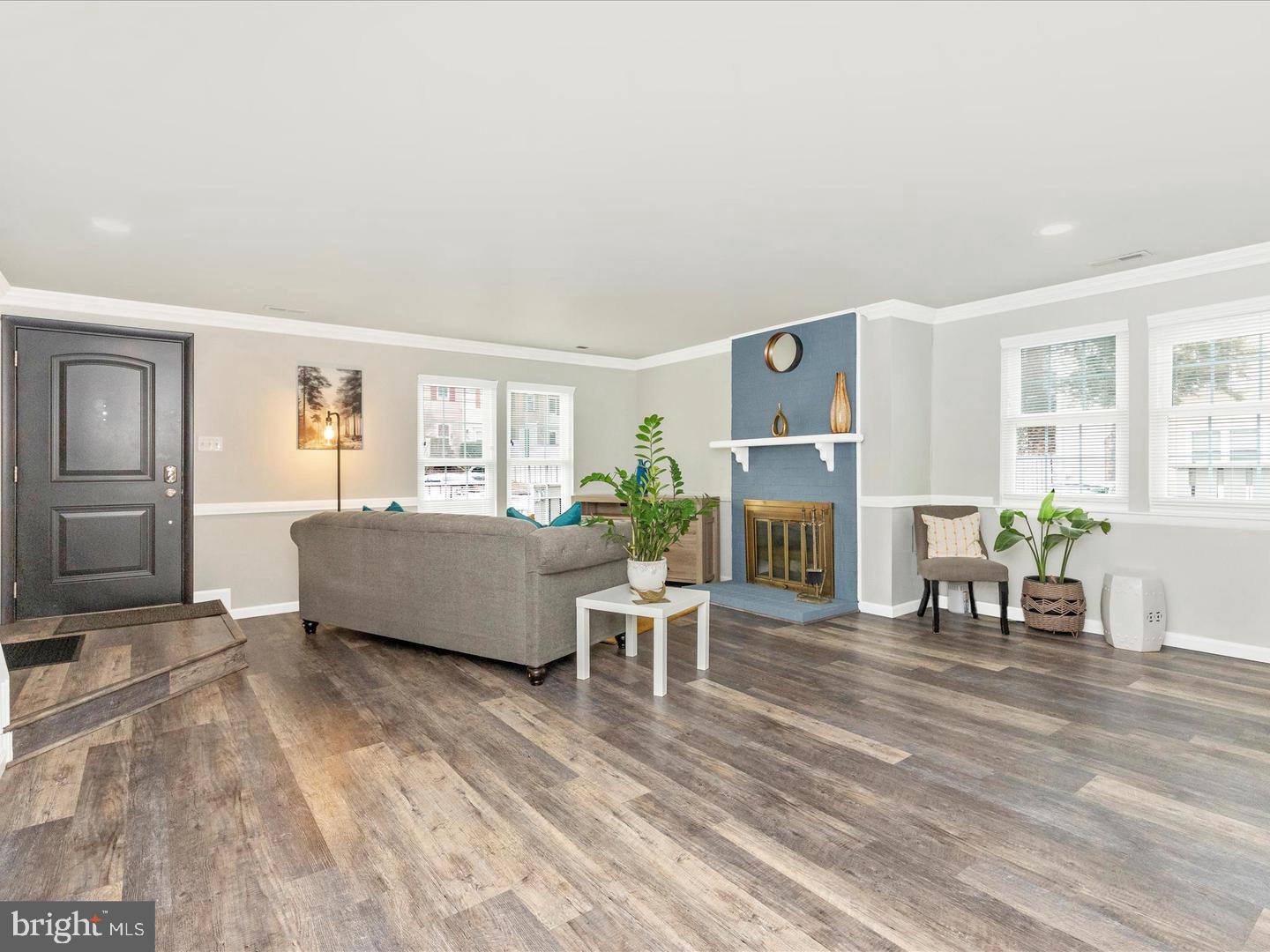 11349 Appledowre Way, Unit 313 Germantown, MD 20876 - Photo 7 of 27 a living room with furniture wooden floor and a fireplace