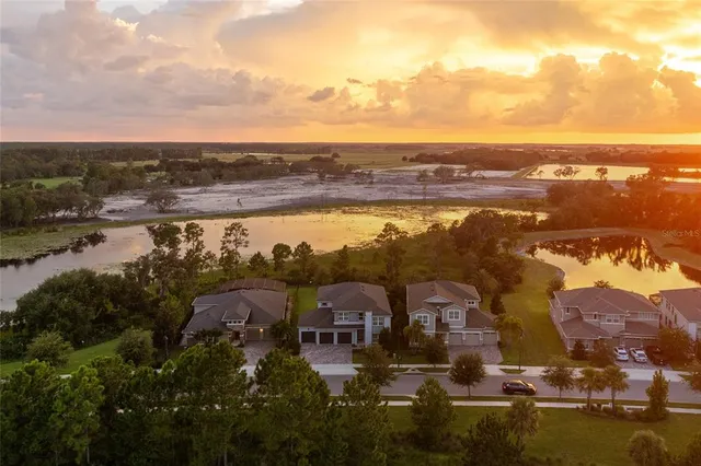 an aerial view of residential building with outdoor space and ocean