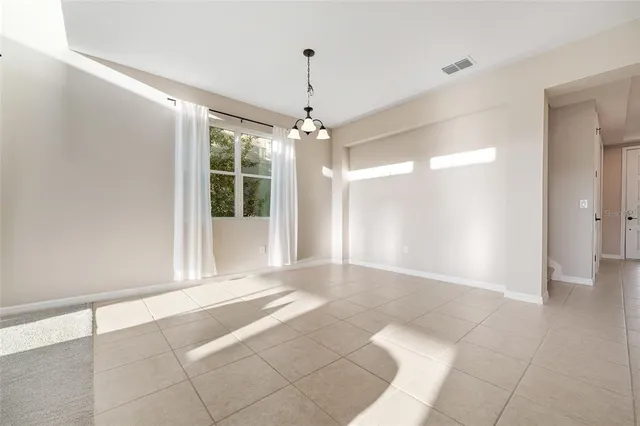 a view of a swimming pool with a yard and palm trees