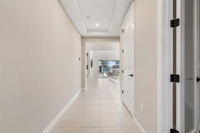 a living room with furniture a flat screen tv and a window