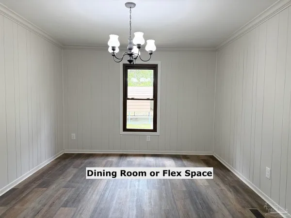 a view of a room with wooden floor chandelier and window