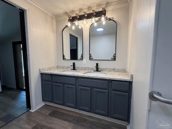 a bathroom with a double vanity sink and mirror